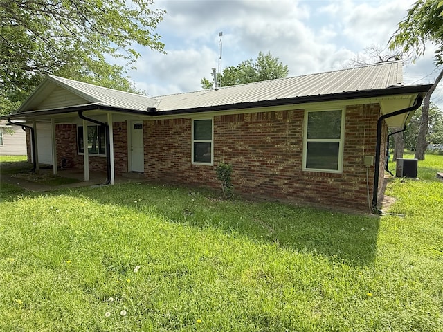 494 Lannius Rd, Dodd City, TX 75438 - view of front of home featuring a front lawn, cooling unit, a garage, and metal roof