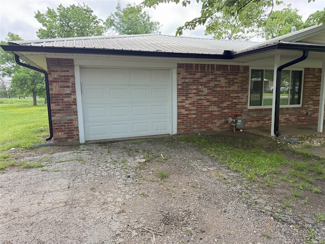 494 Lannius Rd, Dodd City, TX 75438 - view of side of home with an attached garage, brick siding, asphalt driveway, and metal roof