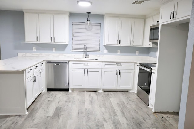 494 Lannius Rd, Dodd City, TX 75438 - kitchen with stainless steel appliances, a sink, a peninsula, light wood-style flooring, and white cabinetry