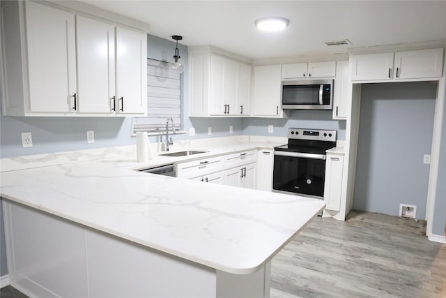 494 Lannius Rd, Dodd City, TX 75438 - kitchen with a sink, stainless steel appliances, a peninsula, and light stone countertops