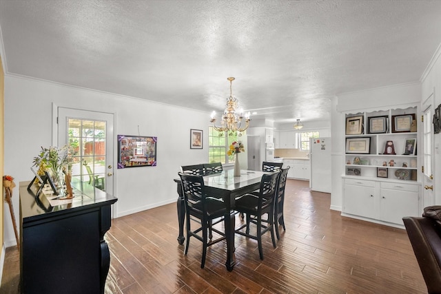 512 N 38th St, Corsicana, TX 75110 - dining area featuring a chandelier, healthy amount of natural light, a textured ceiling, crown molding, and dark wood finished floors