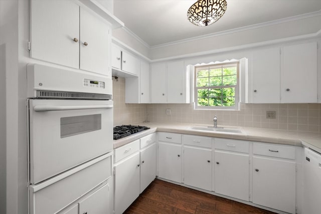 512 N 38th St, Corsicana, TX 75110 - kitchen featuring white appliances, a sink, dark wood-type flooring, tasteful backsplash, and white cabinets