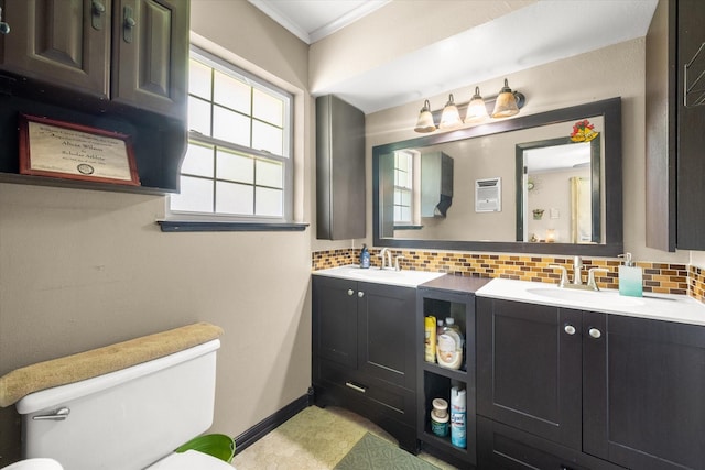 512 N 38th St, Corsicana, TX 75110 - bathroom with decorative backsplash, toilet, ornamental molding, double vanity, and baseboards