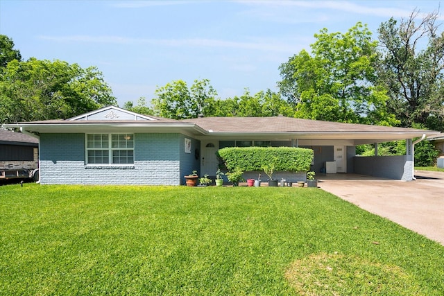 512 N 38th St, Corsicana, TX 75110 - view of front of house featuring a front yard, concrete driveway, an attached carport, and brick siding