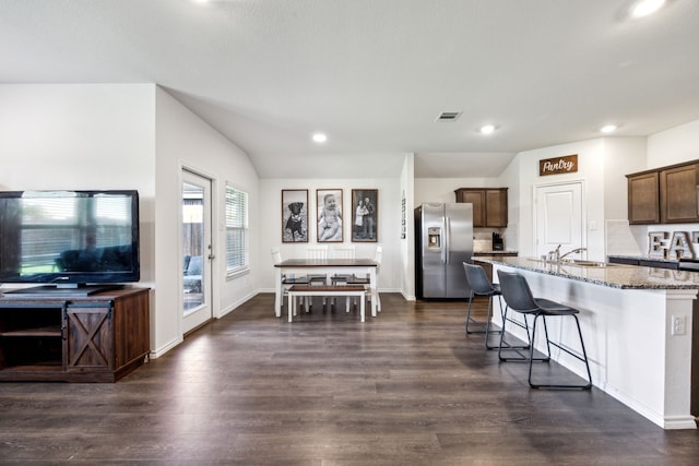 2118 Brisbon St, Fate, TX 75189 - kitchen with stainless steel fridge with ice dispenser, light stone countertops, dark wood-type flooring, a sink, and recessed lighting