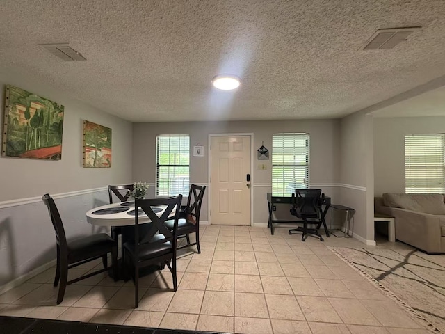 112 Plainview Dr, Wylie, TX 75098 - dining area with a textured ceiling, light tile patterned floors, and baseboards