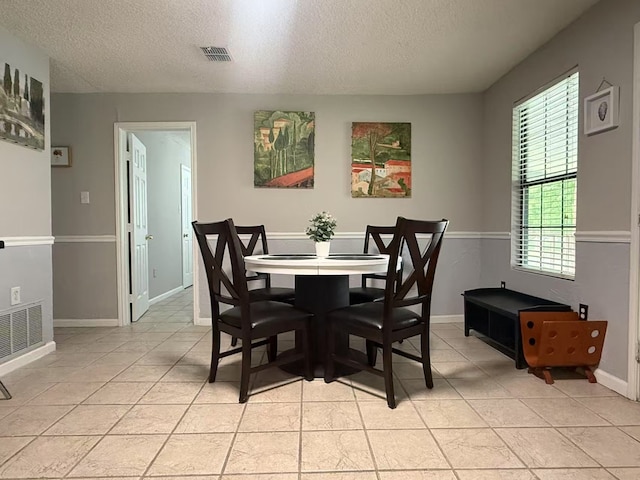 112 Plainview Dr, Wylie, TX 75098 - dining space with a textured ceiling, light tile patterned floors, and baseboards