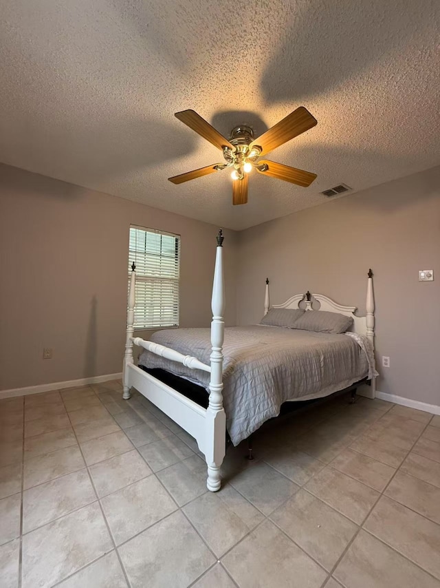 112 Plainview Dr, Wylie, TX 75098 - bedroom featuring light tile patterned floors, a textured ceiling, baseboards, and a ceiling fan