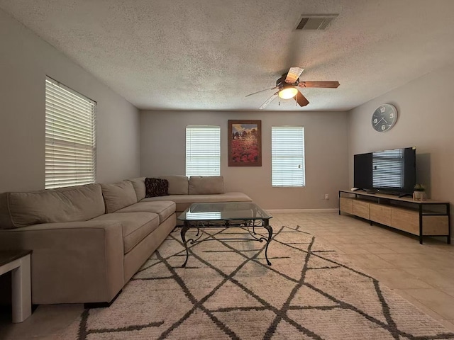 112 Plainview Dr, Wylie, TX 75098 - living area featuring ceiling fan, a textured ceiling, and baseboards