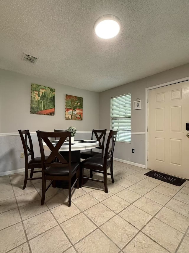 112 Plainview Dr, Wylie, TX 75098 - dining area with a textured ceiling, baseboards, and light tile patterned floors