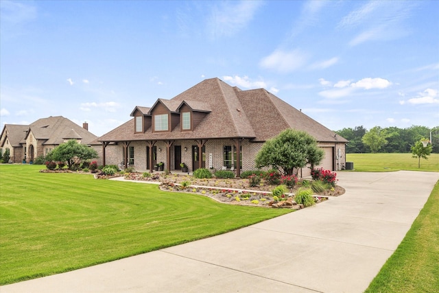 2035 Hodges Lake Dr, Rockwall, TX 75032 - view of front facade featuring concrete driveway, a porch, a front lawn, brick siding, and a garage