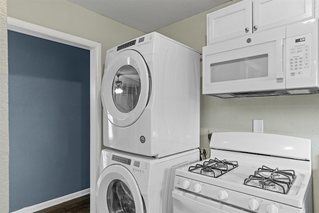3508 Valencia Ct, Fort Worth, TX 76116 - laundry area featuring stacked washing machine and dryer, baseboards, and dark wood-style floors