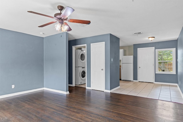 3508 Valencia Ct, Fort Worth, TX 76116 - unfurnished living room with stacked washer / drying machine, a ceiling fan, wood finished floors, and baseboards