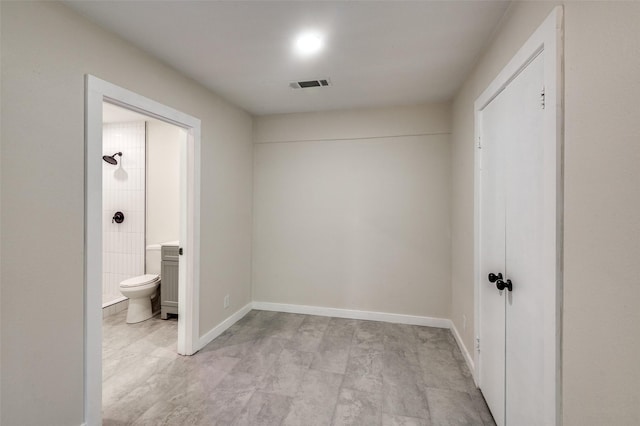 2622 Wynnewood Dr, Dallas, TX 75224 - unfurnished bedroom featuring connected bathroom, a closet, and baseboards