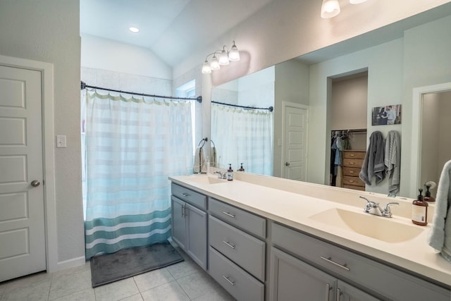 4714 Crestwood Dr, Haltom City, TX 76137 - bathroom featuring tile patterned floors, double vanity, a shower with shower curtain, vaulted ceiling, and a closet