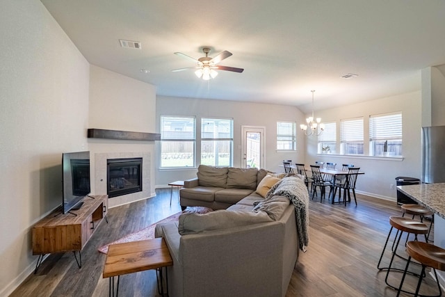 4714 Crestwood Dr, Haltom City, TX 76137 - living area with ceiling fan, a fireplace, a chandelier, baseboards, and dark wood-style flooring