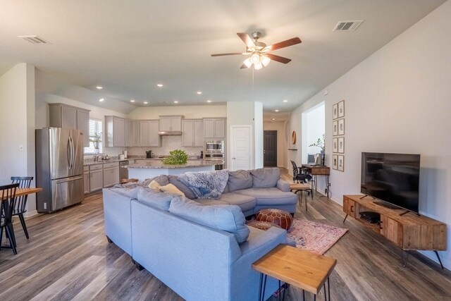 4714 Crestwood Dr, Haltom City, TX 76137 - living room with ceiling fan, wood finished floors, vaulted ceiling, and recessed lighting
