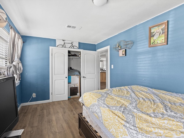 707 Washington St, Ennis, TX 75119 - bedroom with dark wood-style flooring and baseboards