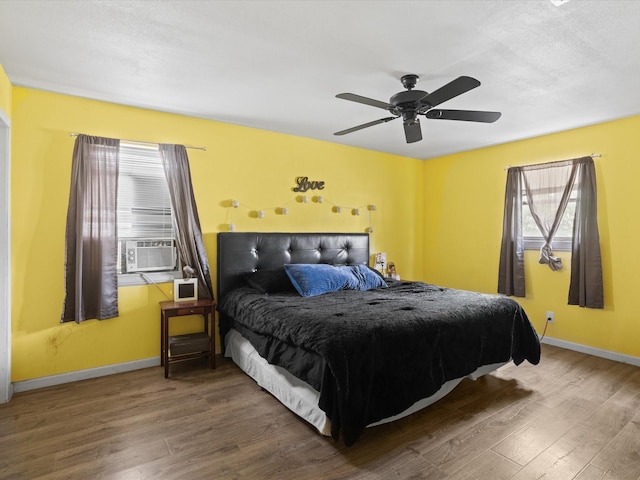 707 Washington St, Ennis, TX 75119 - bedroom featuring wood finished floors, baseboards, ceiling fan, and cooling unit