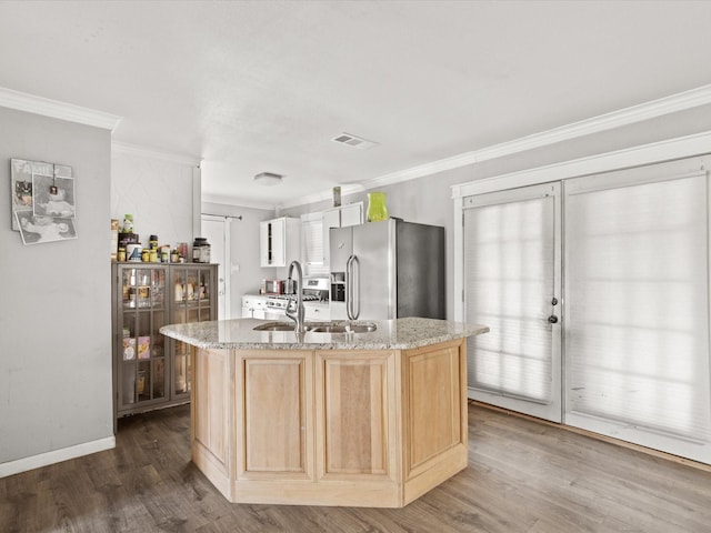 707 Washington St, Ennis, TX 75119 - kitchen with stainless steel fridge, ornamental molding, light brown cabinetry, a sink, and dark wood-type flooring