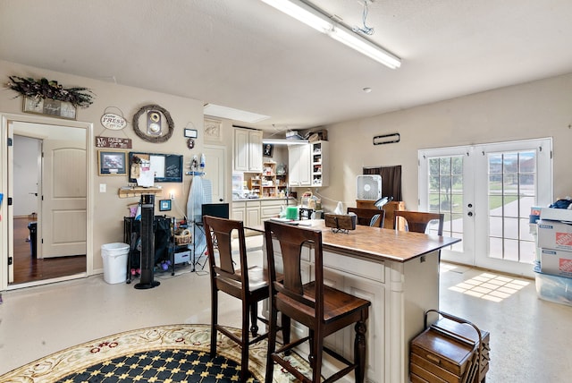 169 Savannah Dr, Brock, TX 76087 - kitchen featuring a kitchen bar, french doors, open shelves, and white cabinets