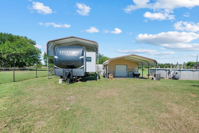 169 Savannah Dr, Brock, TX 76087 - view of yard with a detached garage and a carport