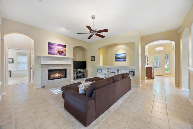 676 Woodland Way, Rockwall, TX 75087 - living area with a tile fireplace, light tile patterned floors, ceiling fan, and baseboards