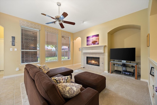 676 Woodland Way, Rockwall, TX 75087 - living room with a tile fireplace, ceiling fan, baseboards, and tile patterned floors