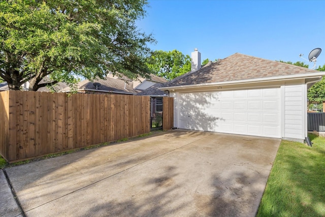 676 Woodland Way, Rockwall, TX 75087 - view of side of home with a chimney, a garage, and roof with shingles