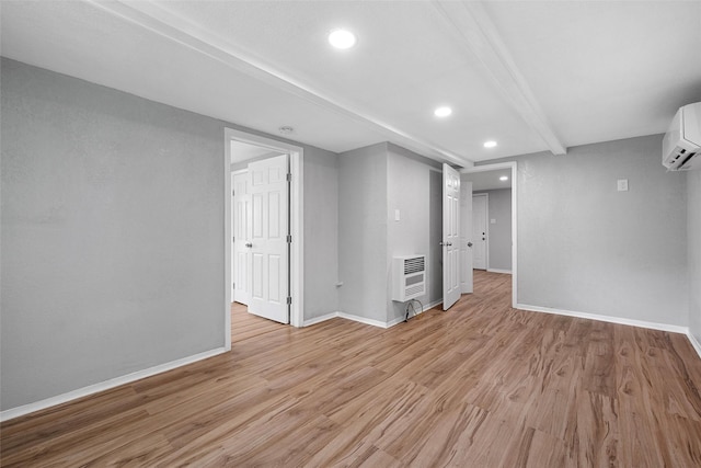 2511 S 7th, Waco, TX 76706 - below grade area with heating unit, recessed lighting, a wall unit AC, light wood-type flooring, and baseboards