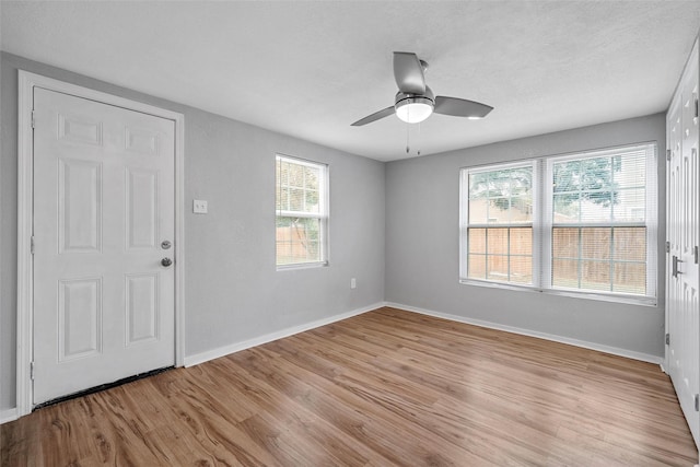 2511 S 7th, Waco, TX 76706 - empty room featuring light wood-type flooring, baseboards, a ceiling fan, and a textured ceiling