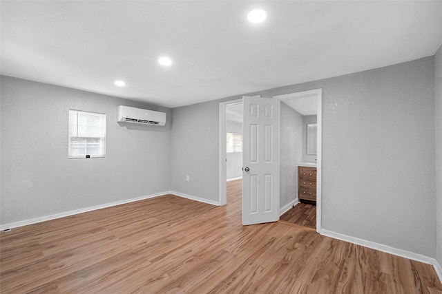 2511 S 7th, Waco, TX 76706 - basement featuring a wall mounted air conditioner, baseboards, recessed lighting, and light wood-style floors