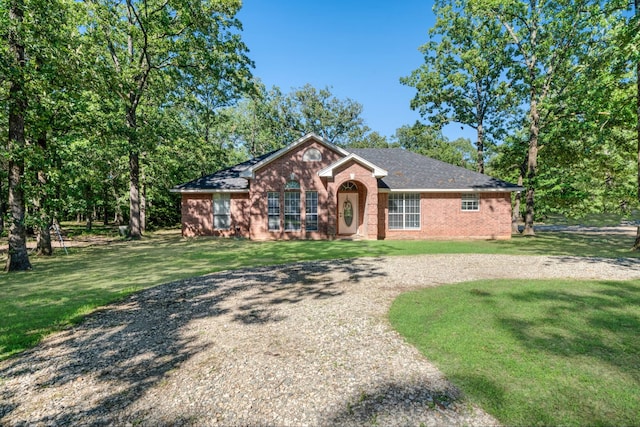 3966 Farm Road 196 N, Paris, TX 75462 - ranch-style home with a front lawn, brick siding, driveway, and a shingled roof