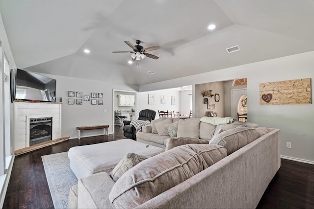 3966 Farm Road 196 N, Paris, TX 75462 - living area featuring vaulted ceiling, a ceiling fan, a fireplace with raised hearth, dark wood-type flooring, and recessed lighting