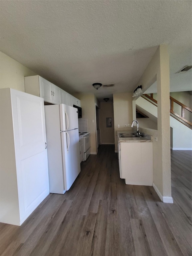 1906 N 4th St, Killeen, TX 76541 - kitchen with white appliances, dark wood-style flooring, a sink, a textured ceiling, and light countertops