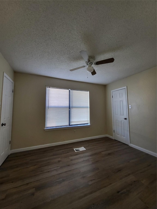 1906 N 4th St, Killeen, TX 76541 - empty room with dark wood-type flooring, a ceiling fan, baseboards, and a textured ceiling
