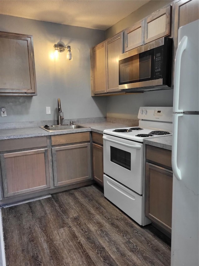 1906 N 4th St, Killeen, TX 76541 - kitchen with white appliances, a sink, dark wood-type flooring, and light countertops
