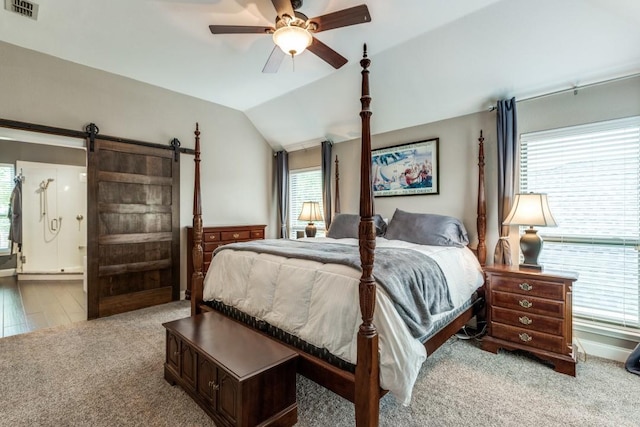 10613 Raleigh Dr, Frisco, TX 75035 - carpeted bedroom featuring vaulted ceiling, connected bathroom, ceiling fan, and a barn door
