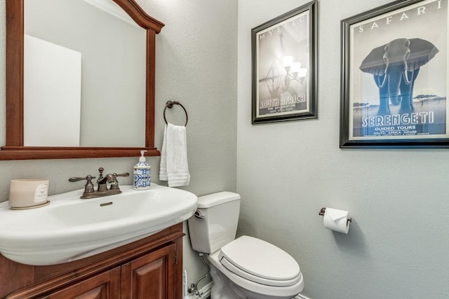 10613 Raleigh Dr, Frisco, TX 75035 - bathroom with toilet, vanity, and a textured wall