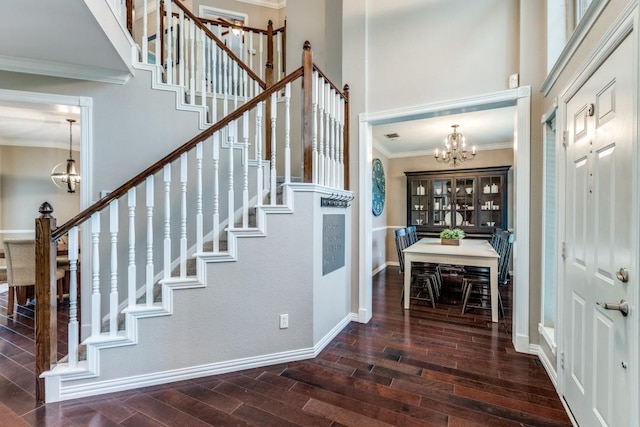 10613 Raleigh Dr, Frisco, TX 75035 - foyer featuring a chandelier, stairway, a towering ceiling, ornamental molding, and wood finished floors