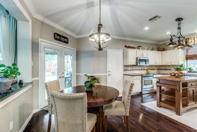 10613 Raleigh Dr, Frisco, TX 75035 - dining room with a chandelier, plenty of natural light, dark wood-style floors, french doors, and ornamental molding
