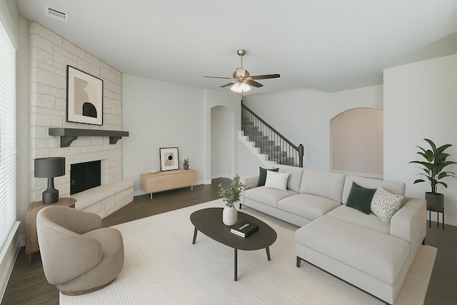 1008 Superbloom Ave, Justin, TX 76247 - living room featuring wood finished floors, ceiling fan, a stone fireplace, stairs, and baseboards
