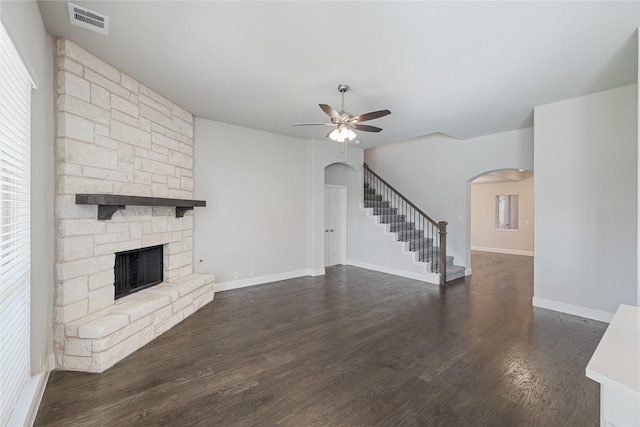 1008 Superbloom Ave, Justin, TX 76247 - unfurnished living room featuring arched walkways, a ceiling fan, stairs, and a fireplace