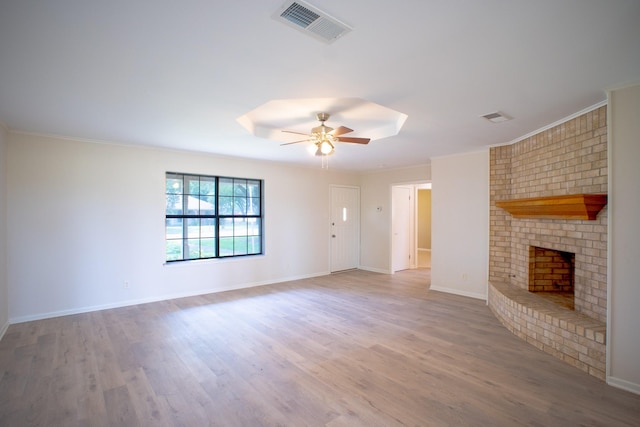 812 Crestline Dr, Mexia, TX 76667 - unfurnished living room featuring a fireplace, a ceiling fan, wood finished floors, baseboards, and crown molding