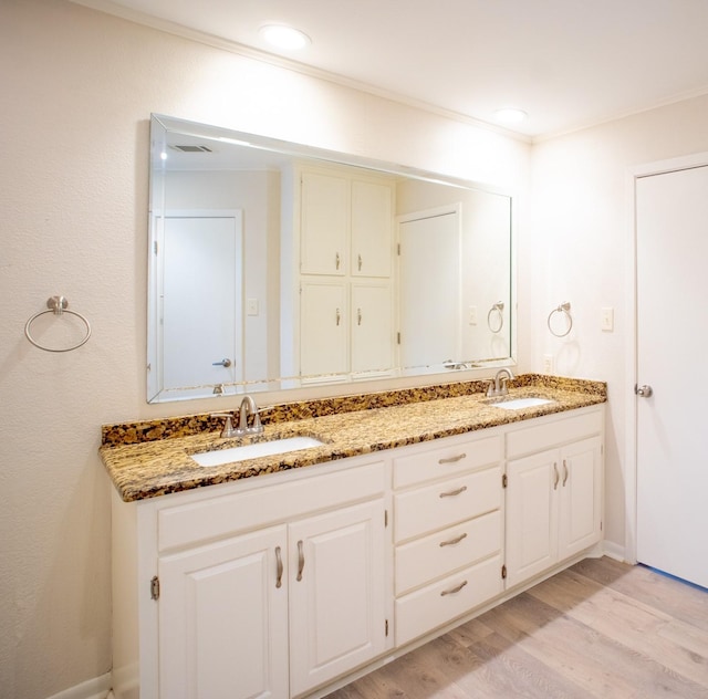 812 Crestline Dr, Mexia, TX 76667 - bathroom with wood finished floors, double vanity, and baseboards