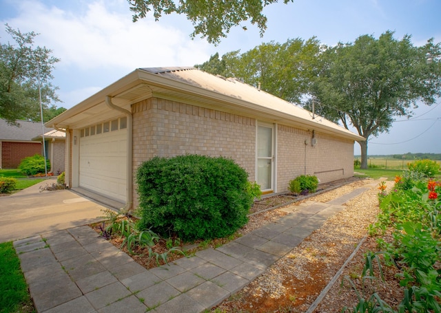 812 Crestline Dr, Mexia, TX 76667 - view of side of home with brick siding and concrete driveway