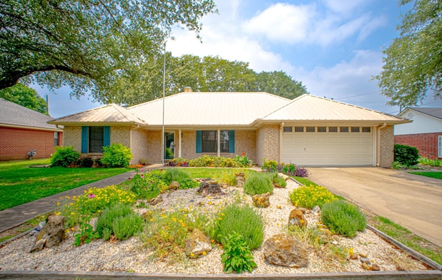 812 Crestline Dr, Mexia, TX 76667 - single story home featuring an attached garage, metal roof, concrete driveway, brick siding, and a front yard