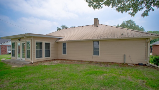 812 Crestline Dr, Mexia, TX 76667 - rear view of property with a chimney, a yard, and metal roof