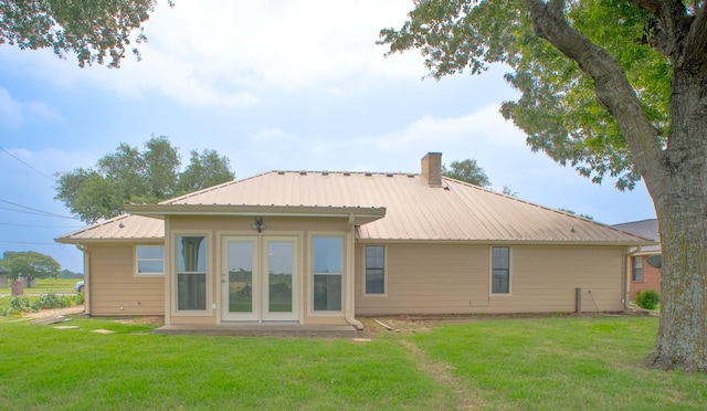 812 Crestline Dr, Mexia, TX 76667 - back of property with a chimney, a lawn, and metal roof