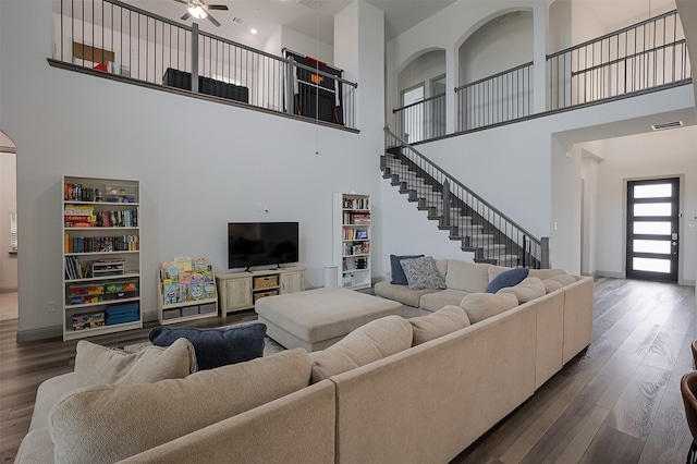 12959 Averi Ln, Farmers Branch, TX 75234 - living area featuring a high ceiling, dark wood-style floors, a ceiling fan, stairway, and baseboards